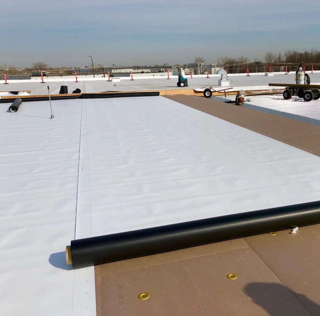 image of a TPO Roof roll being installed on a flat roof in Oakland, CA